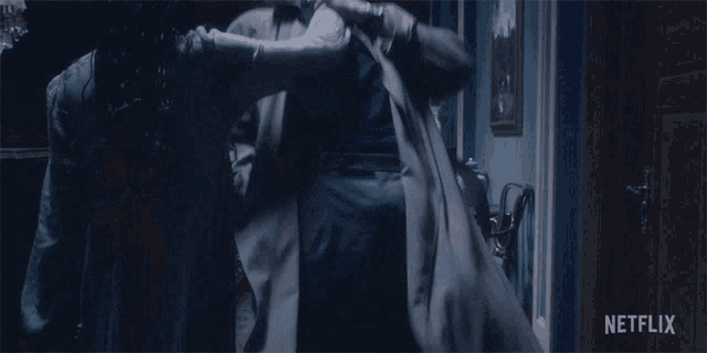 a netflix ad showing a woman holding a man 's arm