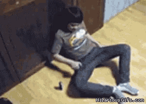 a man is laying on the floor with a bottle of beer in his hand .. hilariousgifs.com