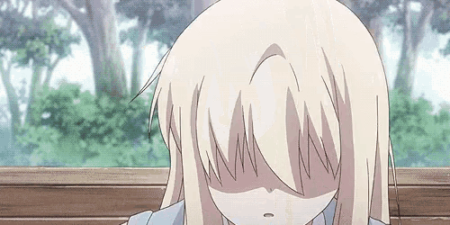 a girl with long blonde hair is covering her face with her hand .