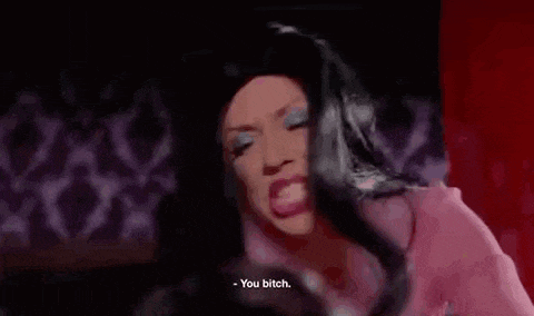 a woman in a pink dress is talking to another woman in a red room .