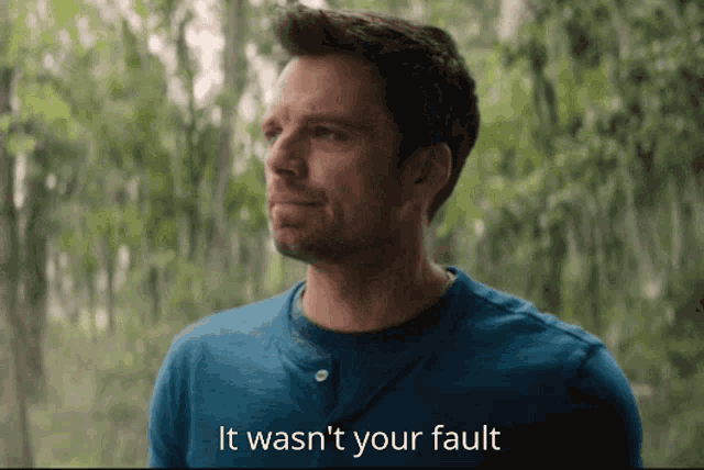 a man in a blue shirt with the words " it wasn 't your fault " below him