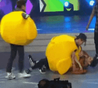 a woman in a yellow costume is laying on the ground