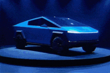 a tesla cybertruck is displayed on a circular pedestal