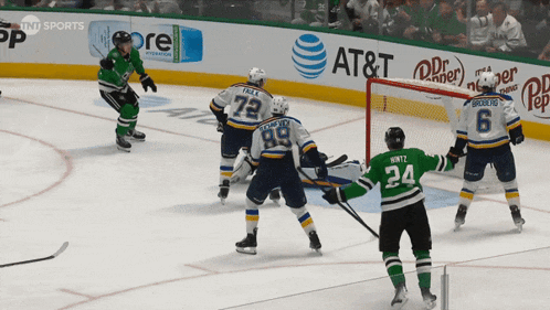 a hockey game is being played in front of an at & t ad