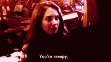 a woman says " you 're creepy " to another woman in a dark room