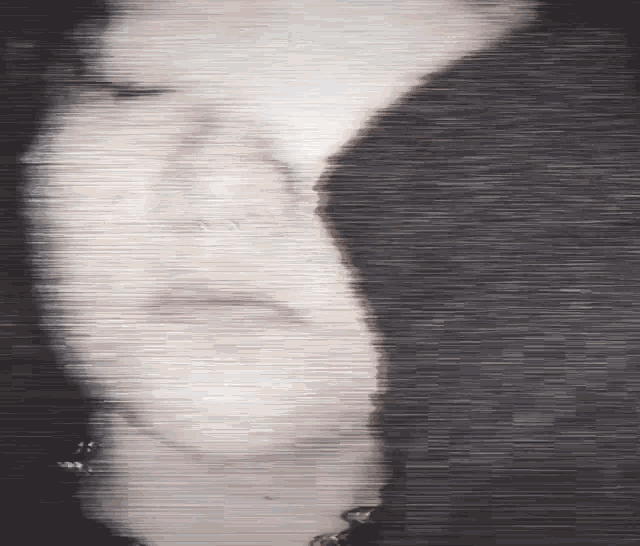 a close up of a person 's face with a blurred background .