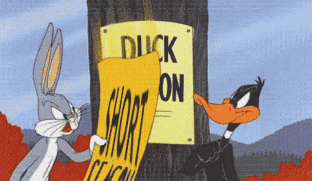 bugs bunny and daffy duck are standing next to a sign that says duck on it