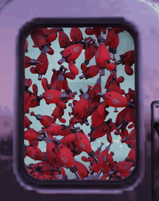 a bunch of stuffed animals are floating in a window