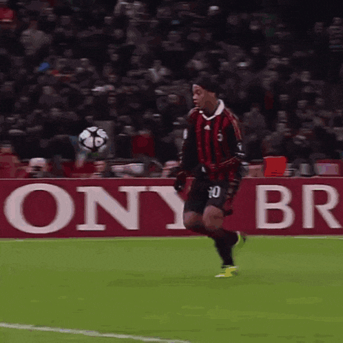 a soccer player with the number 30 on his jersey is kicking a ball