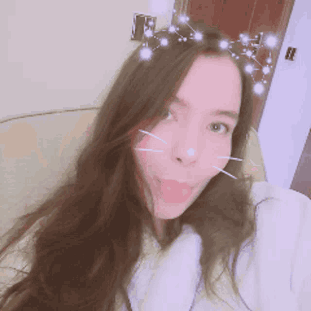 a woman wearing a crown of stars on her head looks at the camera