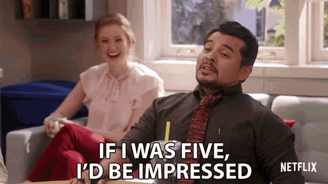 a man sitting on a couch says " if i was five i d be impressed "