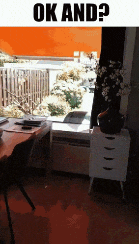 a room with a desk and a vase of flowers and the words ok and on the bottom