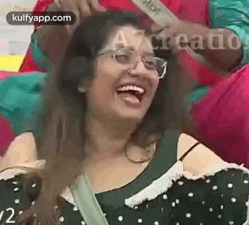 a woman wearing glasses is laughing with her tongue hanging out .