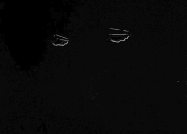a black and white photo of a person 's face with a few white lines on it