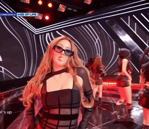 a woman wearing sunglasses on a stage with the words comeback kiss of life