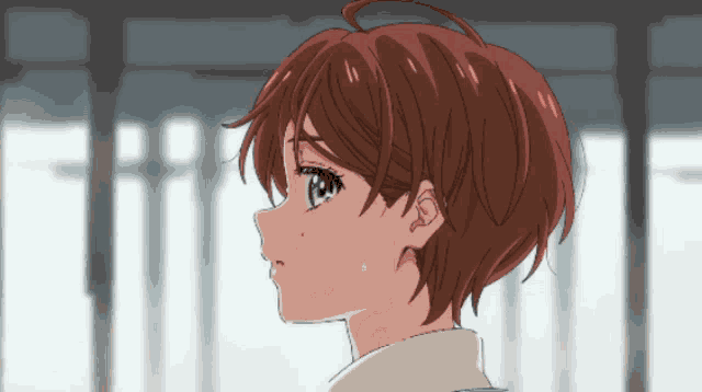 a close up of a girl 's face with red hair