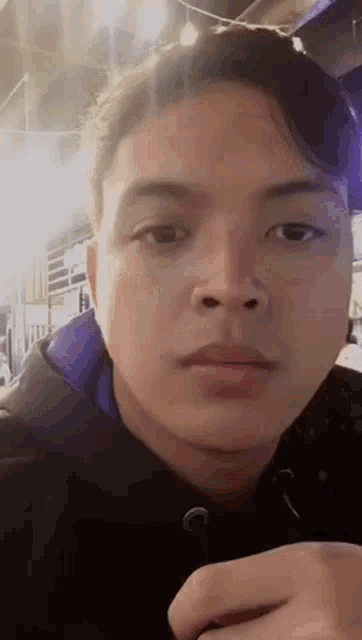 a close up of a young man 's face with a blurred background .
