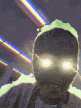 a man with glowing eyes is standing in front of a rainbow