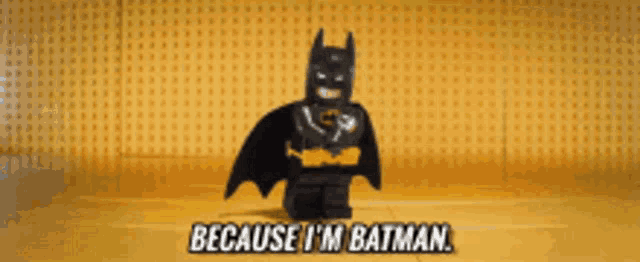 a lego batman says " because i 'm batman " in front of a yellow wall