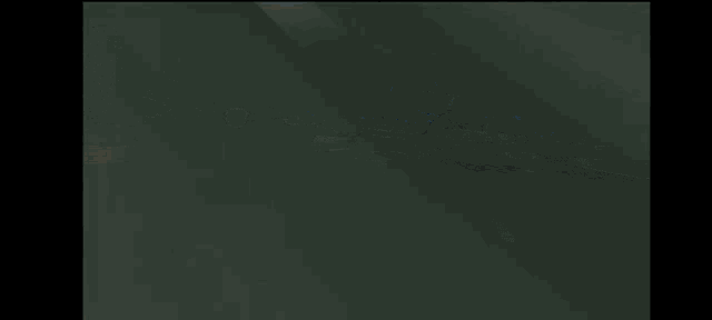 a car is driving down a highway at night with a sign on the right that says ' a '