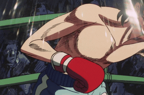a man in a boxing ring with red gloves on