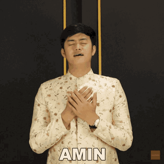 a man in a floral shirt with the word amin on the bottom