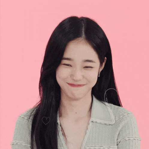 a woman with long black hair is smiling with a heart on her forehead