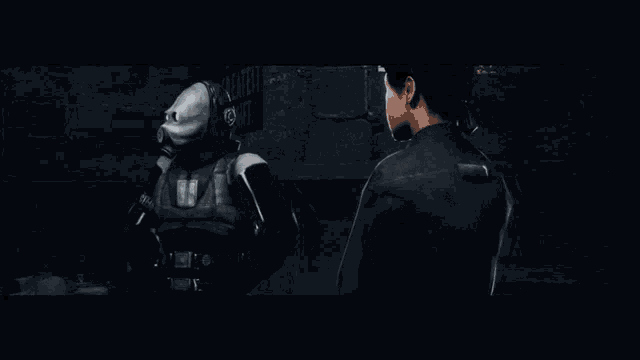 a man in a gas mask is talking to a woman in a dark room