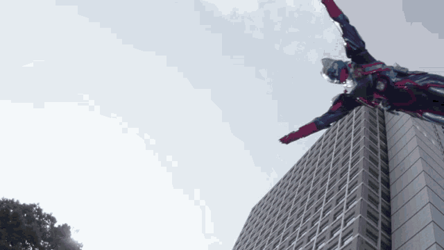 a man in a superhero costume is flying over a building