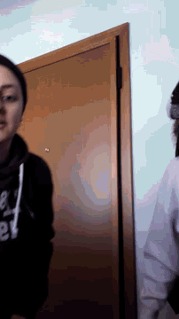a person wearing a black hoodie with the number 80 on the front