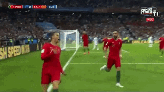 a group of soccer players are running on a field with a sign that says vamos todo