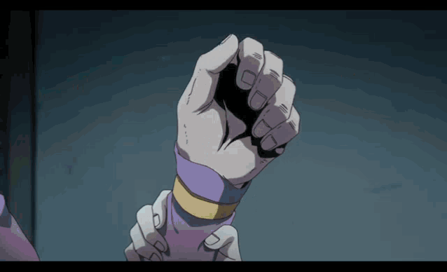 a close up of a person 's fist with a purple glove on