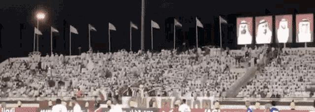 a stadium full of people with flags and a sign that says ' aa '