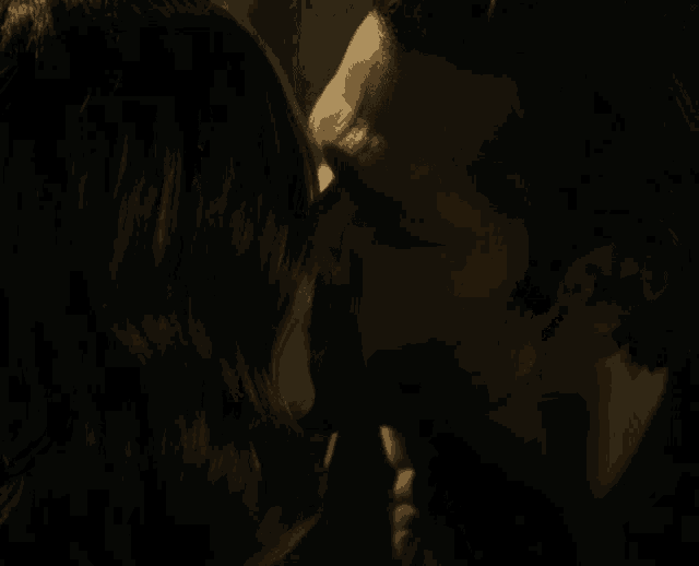 a man and woman are kissing in the dark
