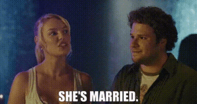 a man and a woman are standing next to each other and the woman is saying she is married .
