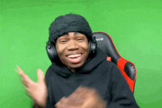 a man wearing headphones and a beanie is sitting in a red chair .