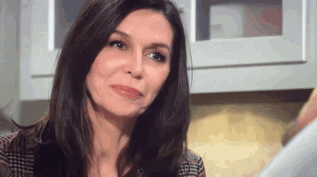 a close up of a woman 's face with a serious look on her face .