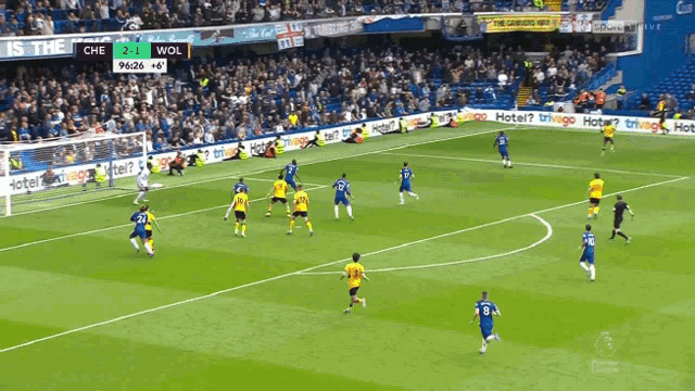 a soccer game is being played in front of a crowd and the score is 2-1 wol