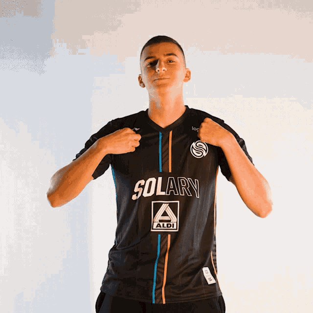 a young man wearing a black shirt that says solary on it