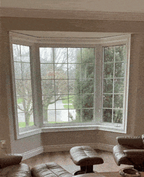 a living room with a bay window and a couch