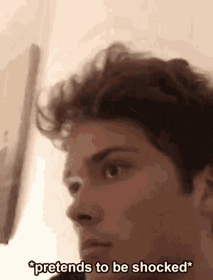 a close up of a man 's face with the words `` pretends to be shocked '' written on it .
