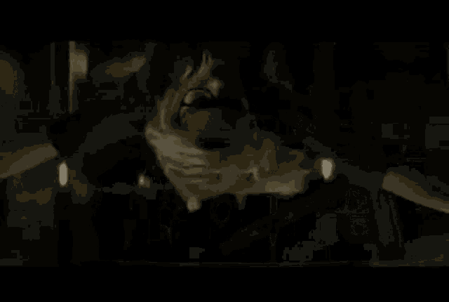 a car is driving down a dark street at night .