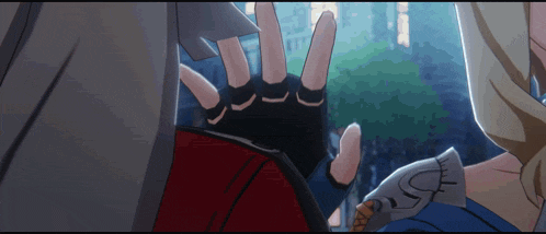 a person 's hand is reaching out towards another person