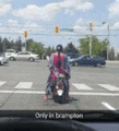 a person is riding a motorcycle on a street in birmingham .