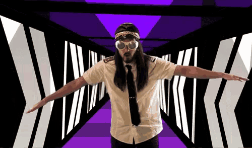 a man wearing a hat and goggles is standing in a purple tunnel