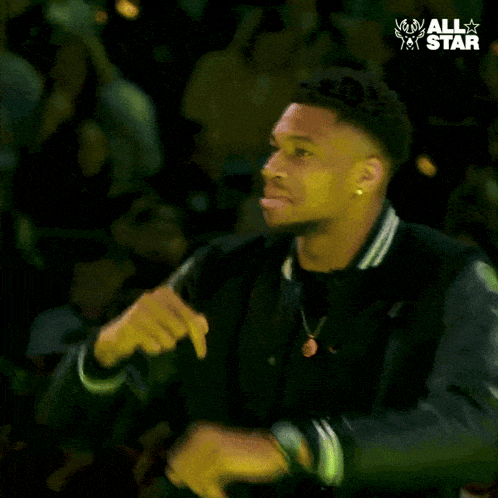 a man in a black jacket with his mouth open and the words all star behind him