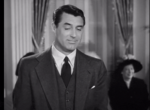 a black and white photo of a man in a suit