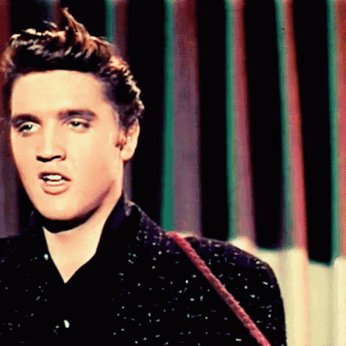 a close up of elvis presley 's face in front of a striped wall