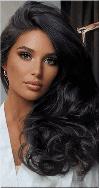a woman with very long black hair is wearing a white robe