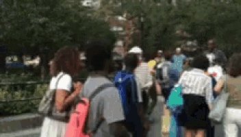 a blurry picture of a crowd of people with backpacks
